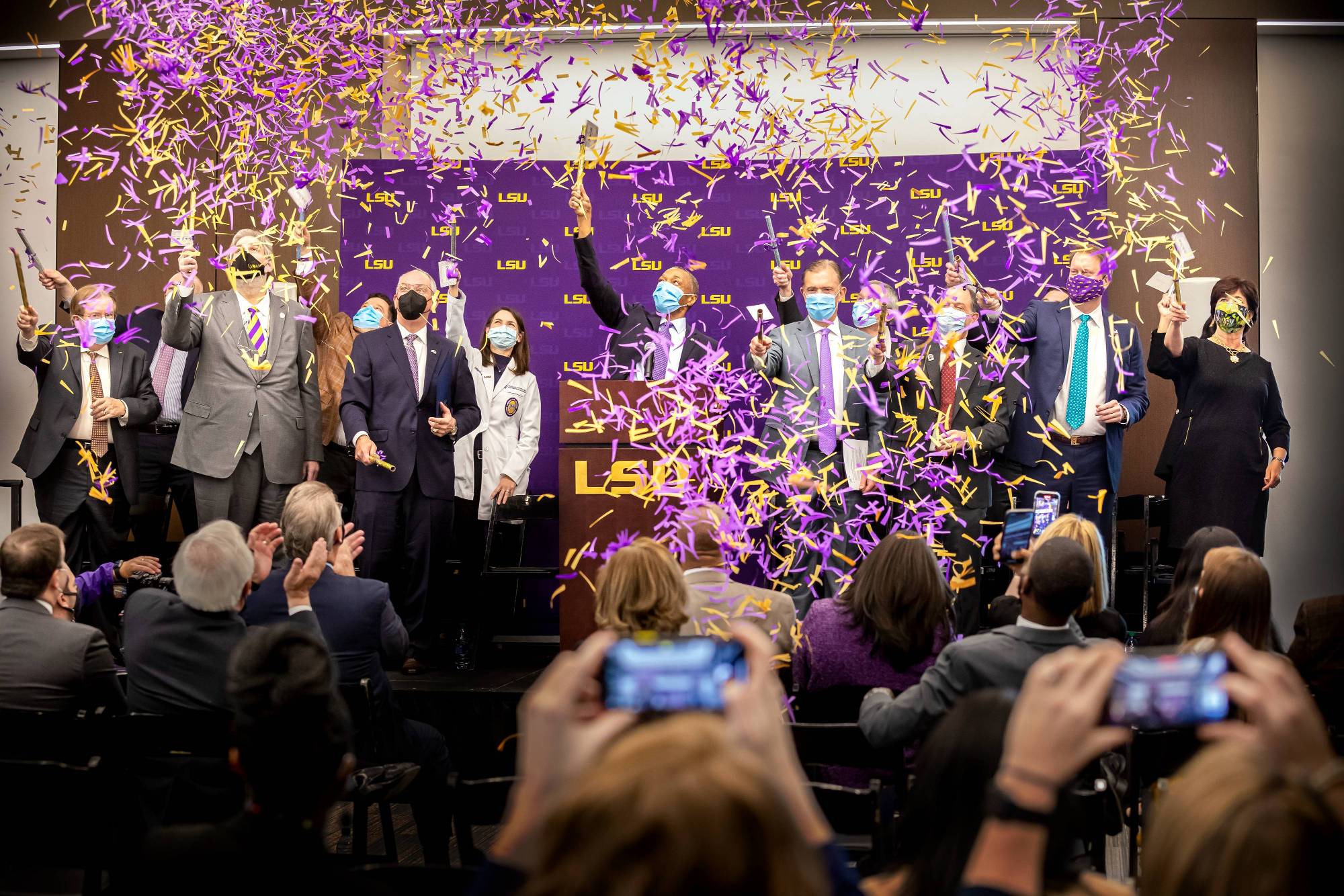 LSU officials and healthcare partners celebrate with confetti at news conference