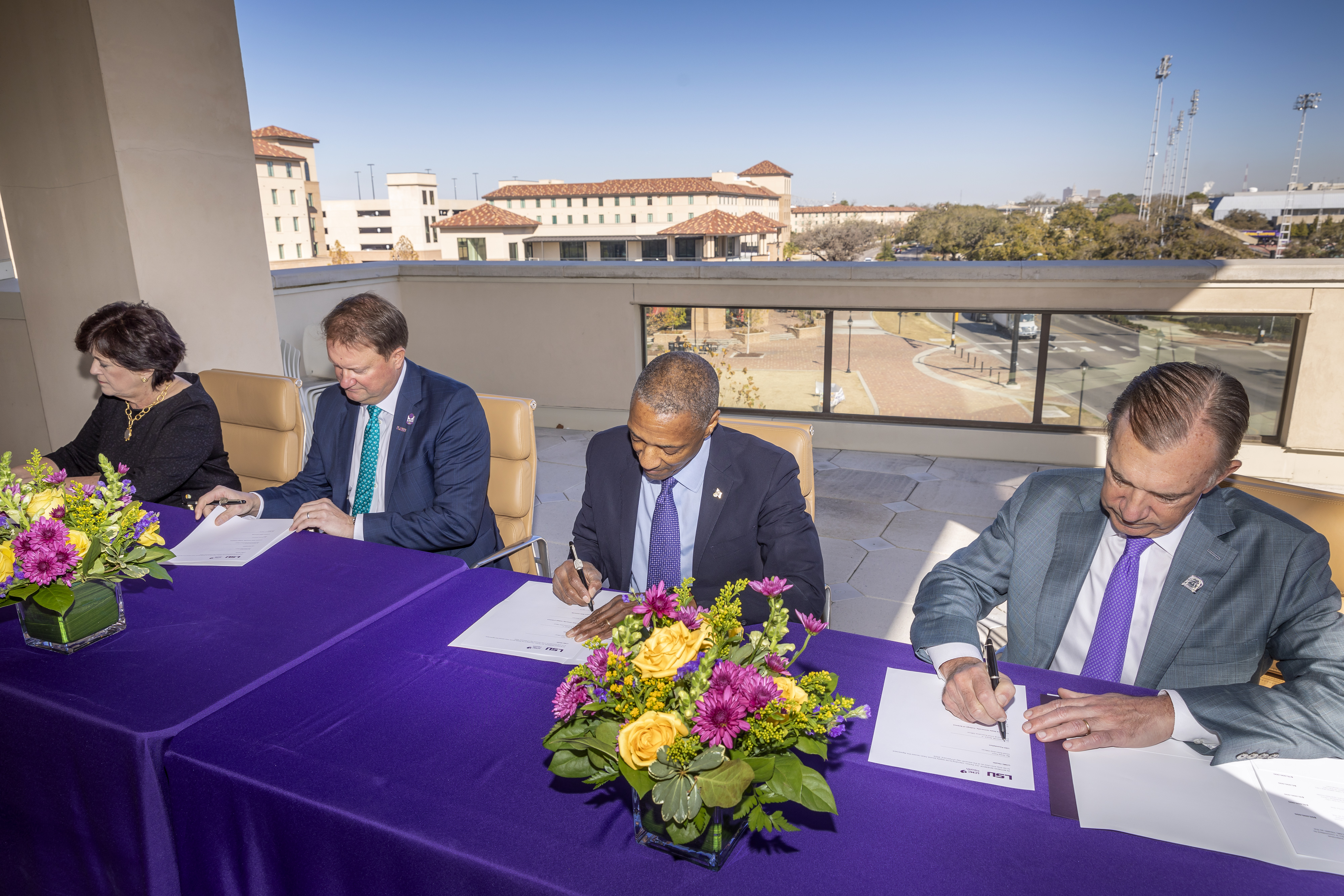 LSU officials, along with representatives from Our Lady of the Lake Health and LCMC Health, sign the $245 million commitment
