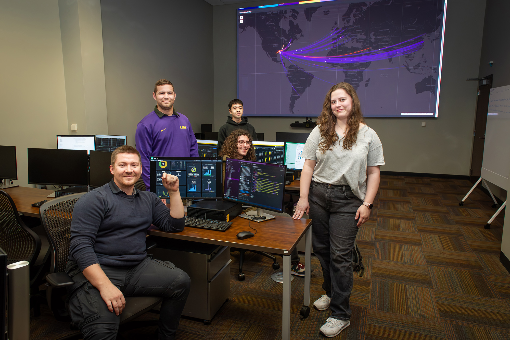 Students Easton Kling, Micah Champagne, Ellen Hoffman, Spencer Malone and Timmy Tran work in LSU’s Security Operations Center to protect Louisiana against cyber threats.