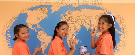 students painting world map