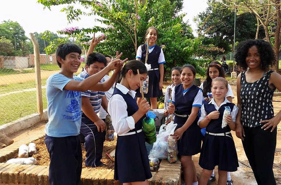 volunteer leading children in recycling project