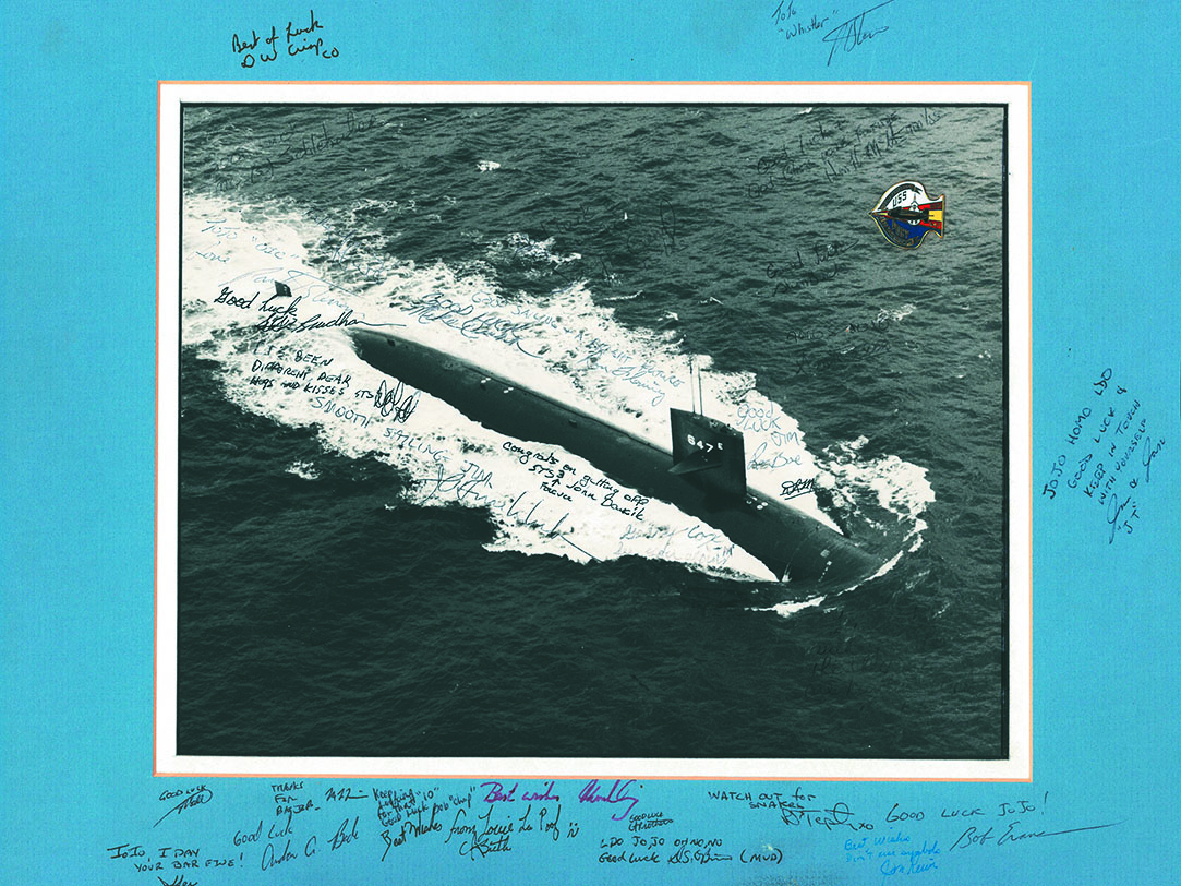 Photo of U.S. Navy submarine the USS Pogy, covered with signatures