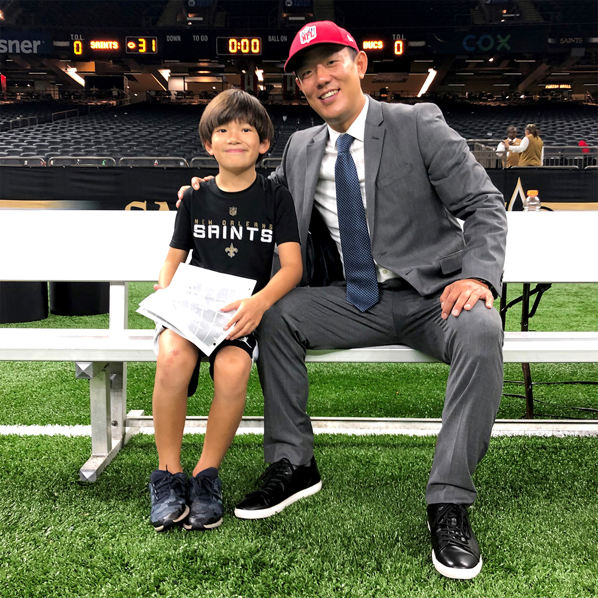 Dr. Jeffrey Kuo on the Saints field with his son Skyler