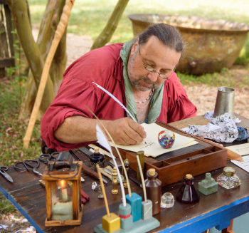 Man writing with quill pen