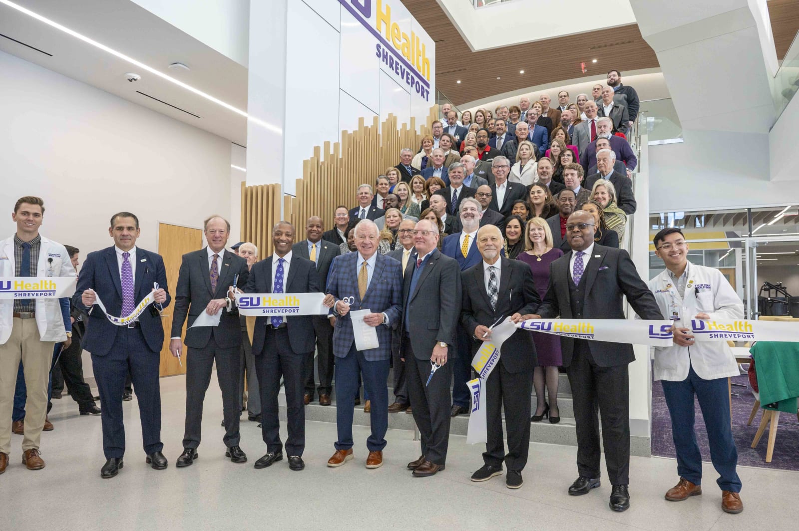 LSU President Tate, Gov. John Bel Edwards and others take part in a ribbon cutting inside the new medical education building.