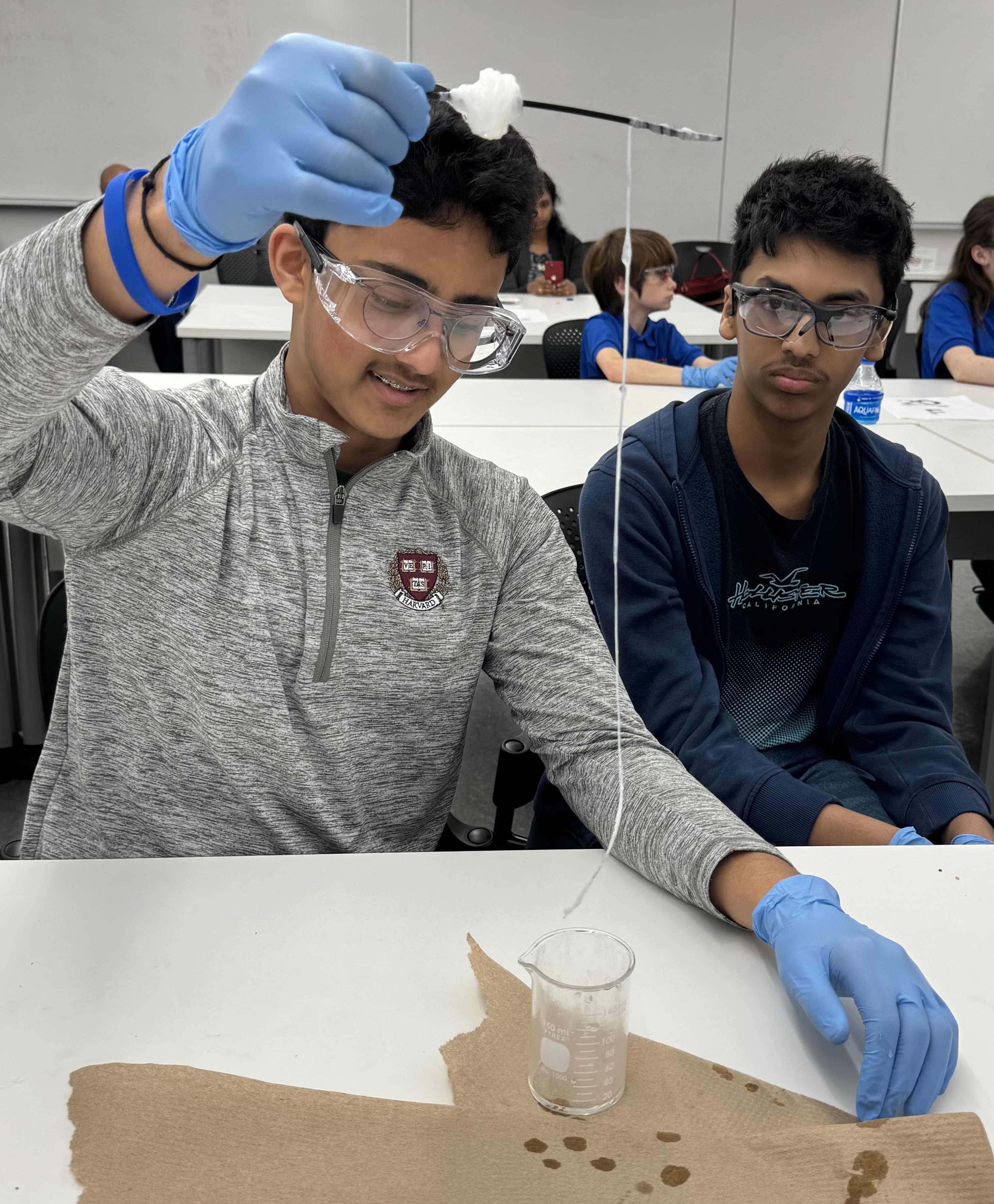 two middle school students creating nylon string