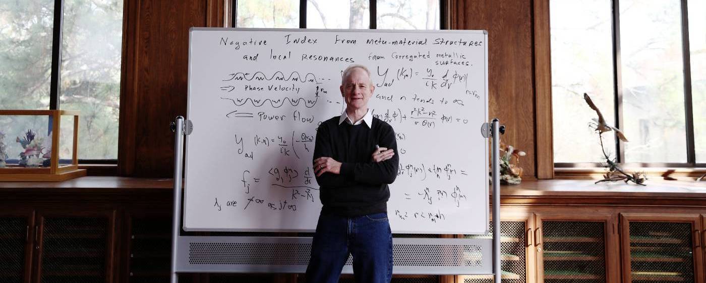 Math professor standing before a white board