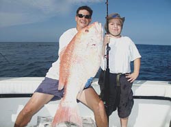 Photo: Zachary Aucoin proudly hold up his red snapper catch.