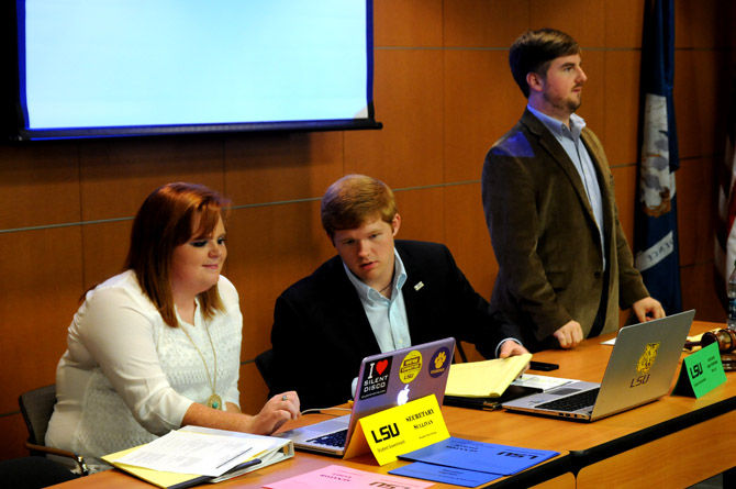 student senate leaders confer behind desk
