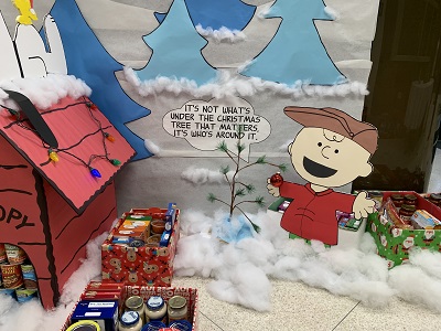 Charlie Brown by the Christmas Tree collecting Food Donations