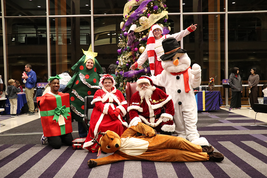 costumed staff with Santa and Mrs. Claus