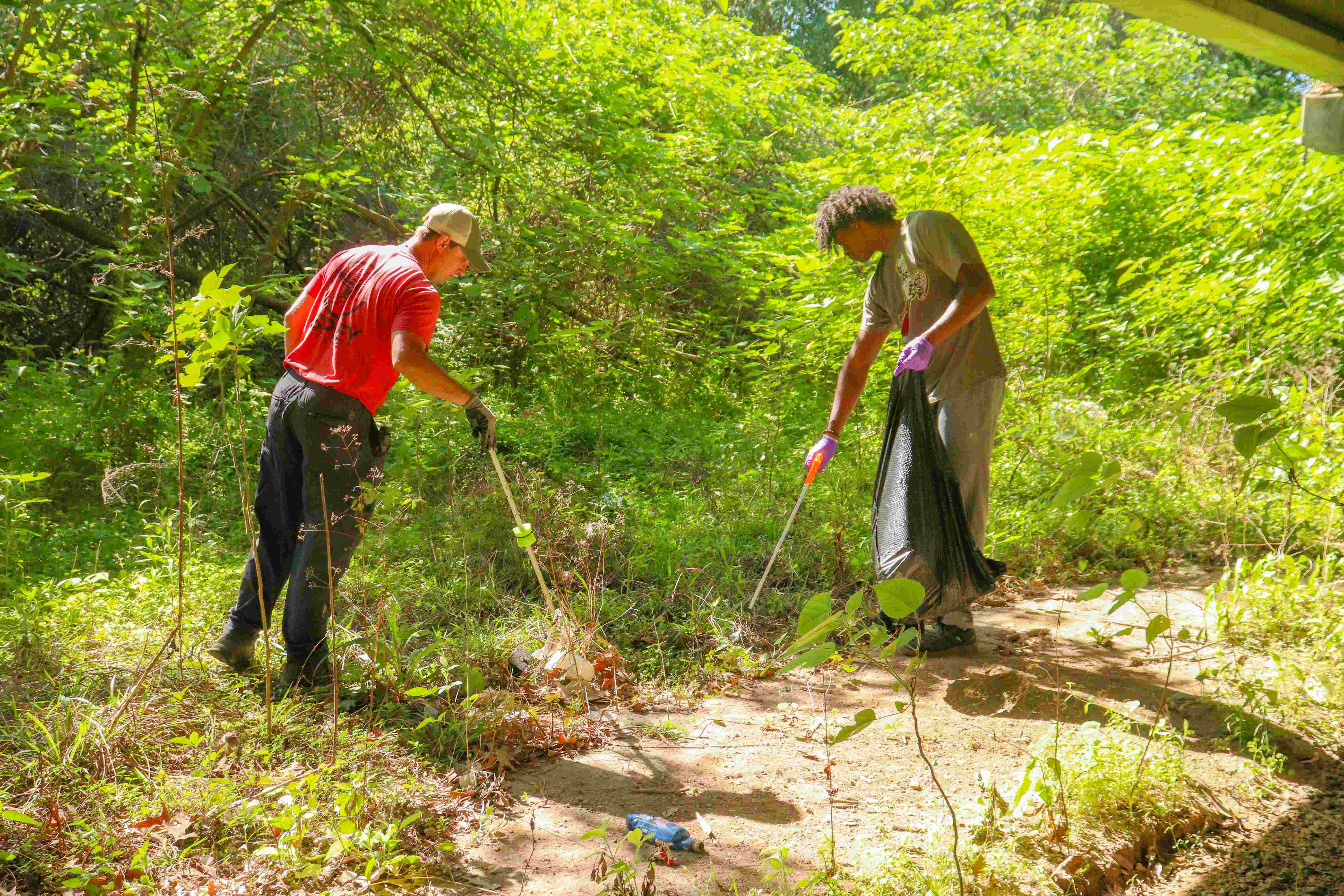 two men picking up recycleables