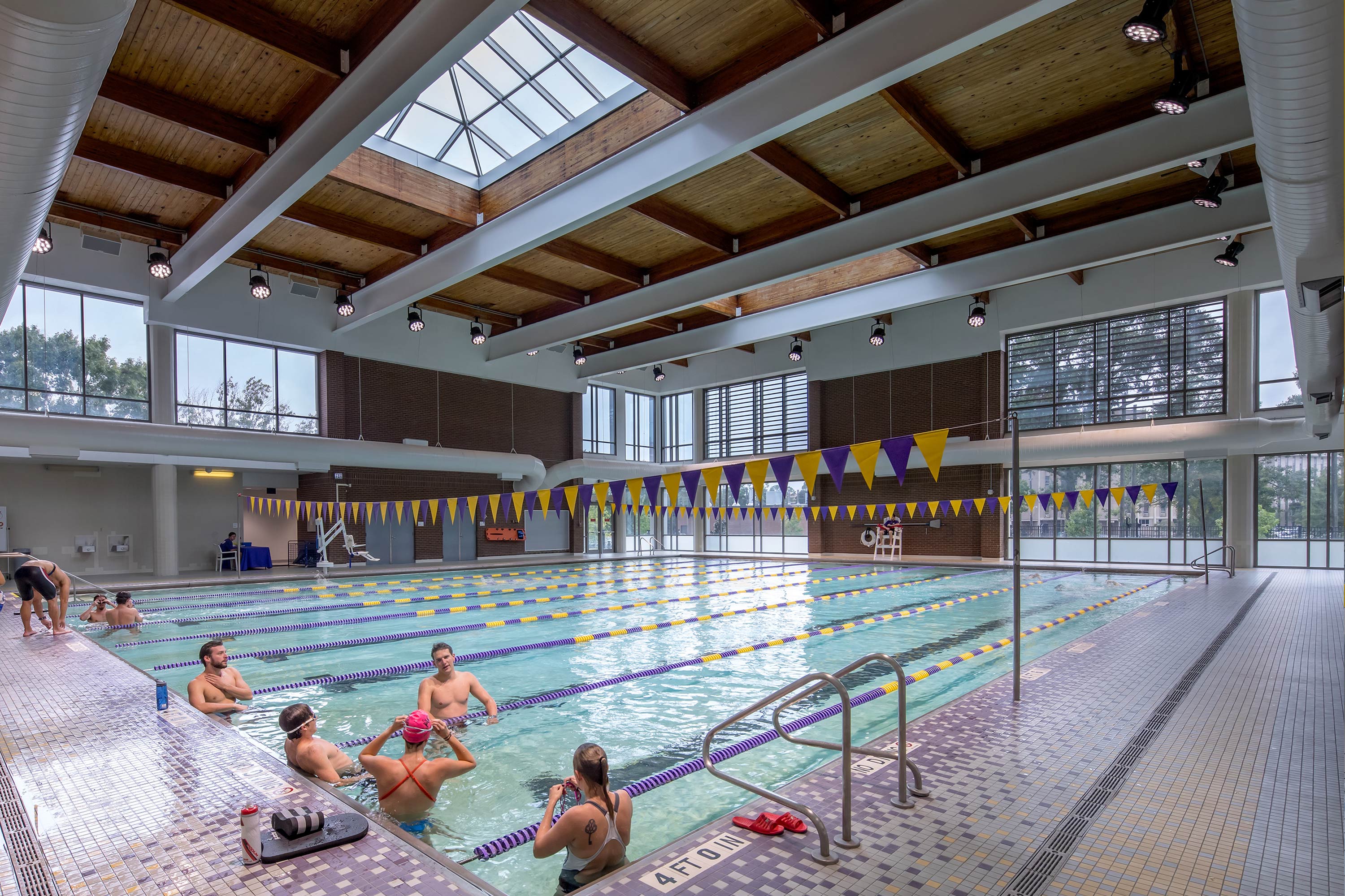 Indoor Pool area with swimmers in lanes
