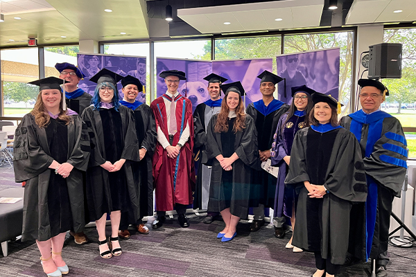 group photo of graduates and mentors at MS-PhD commencement