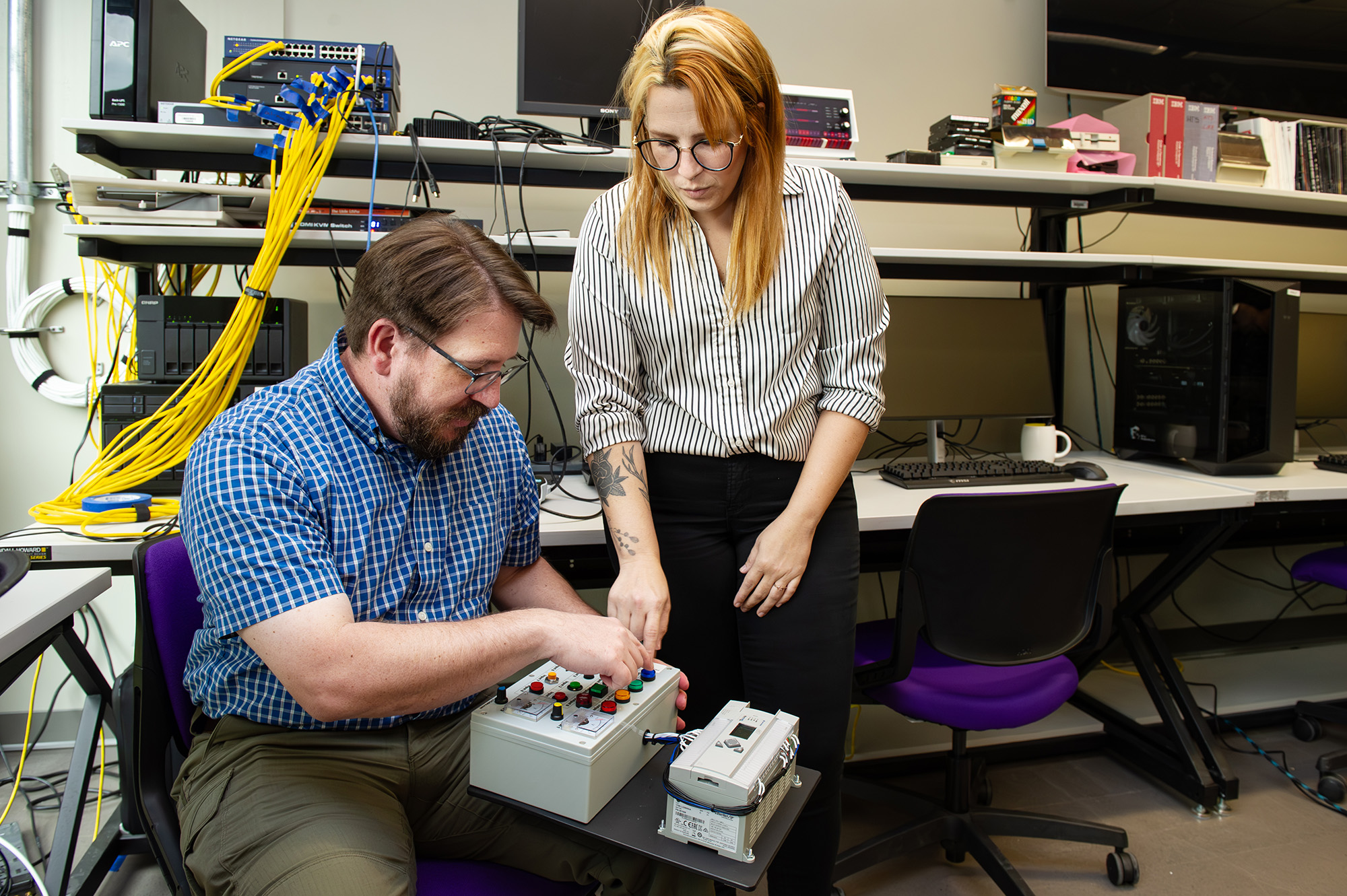 Devin King with Louisiana State Police’s Cyber Crime Unit and LSU graduate student Nathalia Soares.